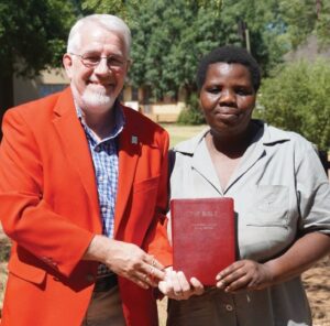 Brian presents his WBS Presentation Bible to Sondra, an accomplished WBS Student in South Africa.