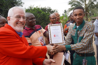 Brian Rex Davis delivering certificate to Nigerian Student